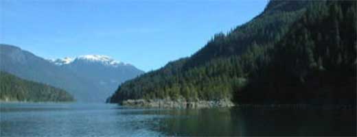 A scenic image of a body of water and mountains in British Columbia.