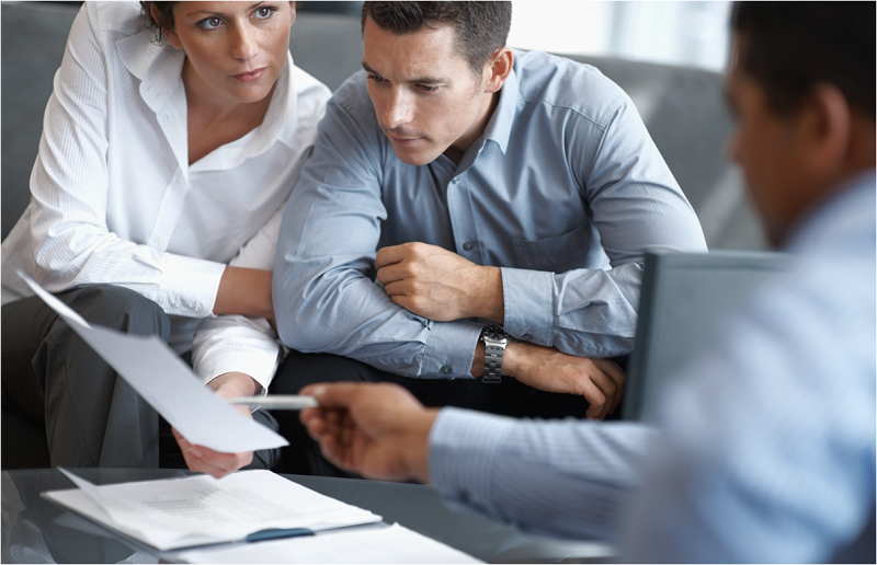 Three people discussing a document