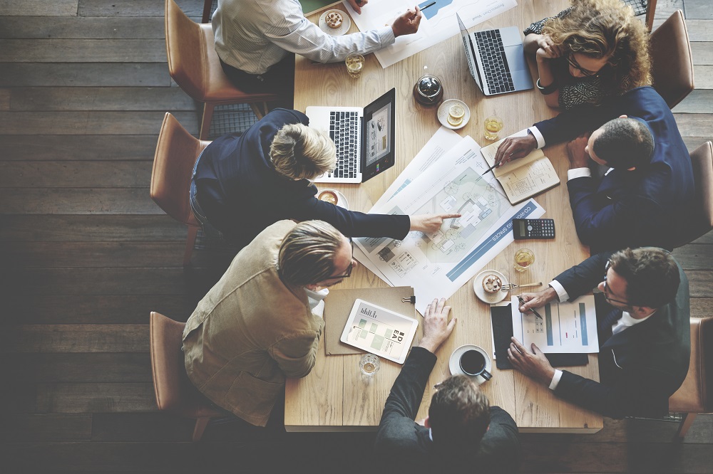 A group of people looking at documents together