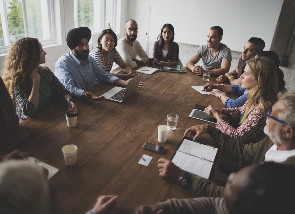 A team of people working around a table